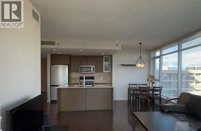 Richmond apartment for rent - A modern living room with a kitchen area in the background.