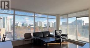 Richmond apartment for rent - A living room with a large window overlooking a cityscape.