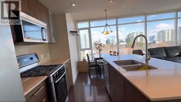 Richmond apartment for rent - A kitchen with a stove top oven and a microwave above it.