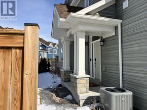 Collingwood townhouse for rent - A house with a porch and a wood fence.