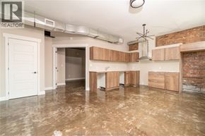Chatham apartment for rent - A large, empty room with a kitchenette area and a doorway leading to another room.
