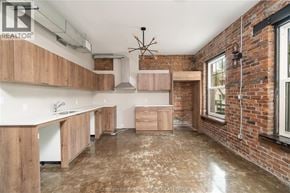 Chatham apartment for rent - A kitchen with wooden cabinets and a brick wall.