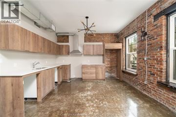 Chatham apartment for rent - A kitchen with wooden cabinets and a brick wall.