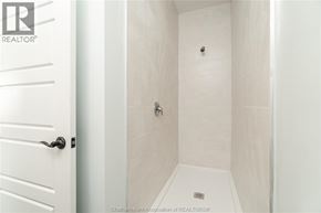 Chatham apartment for rent - A white bathroom with a shower and a door.