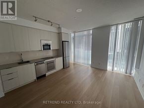 Toronto (Mount Pleasant West) condo for rent - A spacious kitchen with wooden flooring and modern appliances.