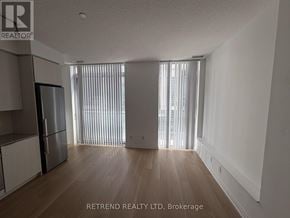 Toronto (Mount Pleasant West) condo for rent - A spacious room with wooden floors and a large window with blinds.
