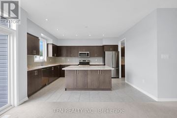 Brock (Sunderland) apartment for rent - A modern kitchen with brown cabinets and a white countertop.