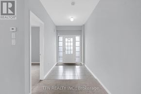 Brock (Sunderland) apartment for rent - A hallway with a door at the end and a sign that says TEN REALTY INC. Brokerage.
