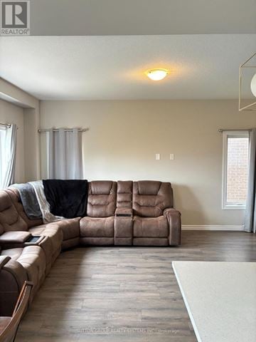 Woodstock (Woodstock - North) apartment for rent - A brown leather sectional sofa in a living room.