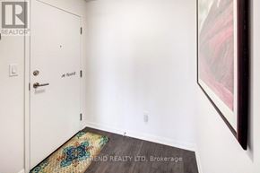 Toronto (Moss Park) condo for rent - A hallway with a door and a rug on the floor.