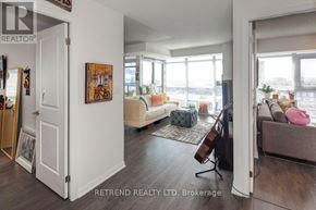 Toronto (Moss Park) condo for rent - A living room with a couch, a chair, and a painting on the wall.