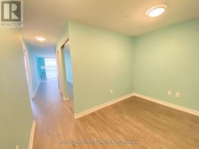 Toronto (Agincourt South-Malvern West) condo for rent - A room with light blue walls and wooden floors.