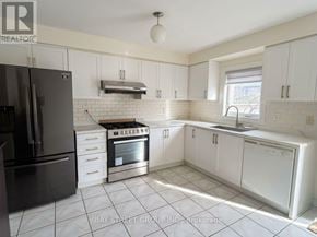Markham (Cedarwood) apartment for rent - A kitchen with white cabinets and a black refrigerator.