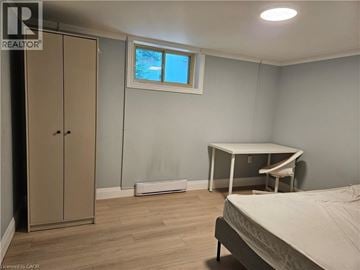 Hamilton apartment for rent - A bedroom with a bed, desk, and wardrobe.