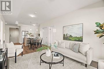 London North (North B) apartment for rent - A living room with a white couch, a coffee table, and a painting on the wall.