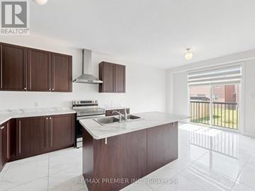 Shelburne apartment for rent - A kitchen with brown cabinets and a white counter top.