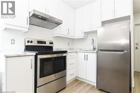 Hamilton apartment for rent - A modern kitchen with stainless steel appliances and white cabinetry.