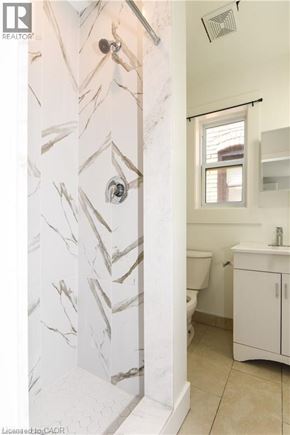 Hamilton apartment for rent - A bathroom with a marble patterned wall.