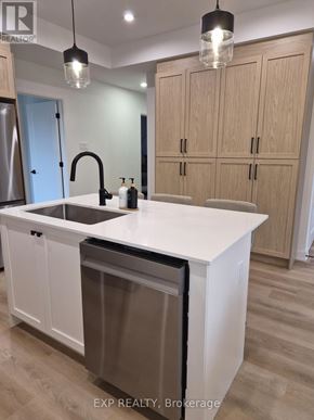 Ottawa multi-family for rent - A kitchen with a white countertop and wooden cabinets.