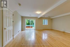 Oakville (Sw Southwest) apartment for rent - A spacious room with wooden floors and a door leading to a balcony.