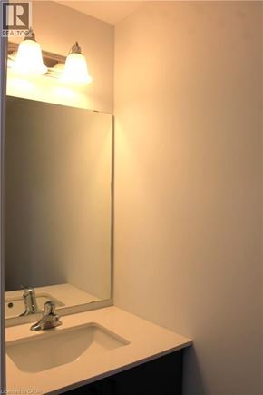 Cambridge townhouse for rent - A bathroom sink under a mirror with lights above it.