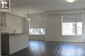 Cambridge townhouse for rent - A well-lit, empty kitchen with a sink and a window with blinds.