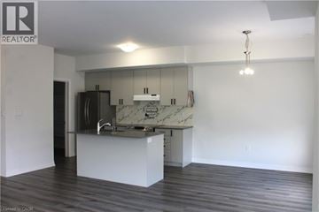 Cambridge townhouse for rent - A kitchen with a marble countertop and a wooden floor.