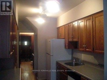 Toronto (Humewood-Cedarvale) apartment for rent - A kitchen with a refrigerator, cabinets, and a sink.