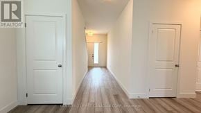 London North (North S) apartment for rent - A hallway with white doors and wooden floors.