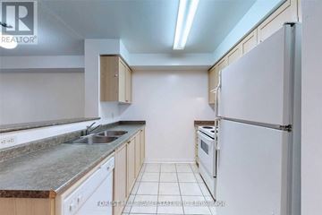 Toronto (Willowdale East) condo for rent - A kitchen with a white fridge, sink and cabinets.