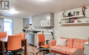 Toronto (Corso Italia-Davenport) duplex for rent - A kitchen with orange chairs and a couch.
