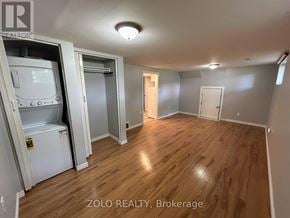 Kitchener apartment for rent - A room with wood flooring and a vintage refrigerator.