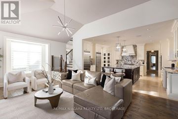 Niagara-On-The-Lake (St. Davids) apartment for rent - A spacious living room with a brown sofa and a coffee table.