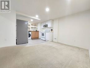 Richmond Hill townhouse for rent - A spacious room with a washer and dryer in it.