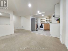 Richmond Hill townhouse for rent - A spacious, empty room with a washer and dryer in it.