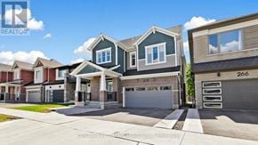 Kitchener apartment for rent - A row of houses with the number 266 on the garage door.