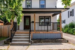 Niagara Falls (Downtown) apartment for rent - A house with a front porch and a black railing.