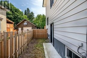 Niagara Falls (Downtown) apartment for rent - A backyard with a wooden fence and a shed.