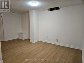Markham (Middlefield) apartment for rent - A room with wooden flooring and white walls, with a light fixture on the ceiling.