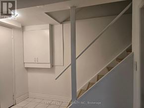 Markham (Middlefield) apartment for rent - A white hallway with a staircase and a cabinet.