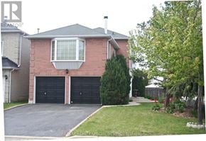 Mississauga (Meadowvale) apartment for rent - A house with a brick facade and a large driveway.