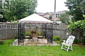 Mississauga (Meadowvale) apartment for rent - A white gazebo with a table and chairs is set up in a backyard.