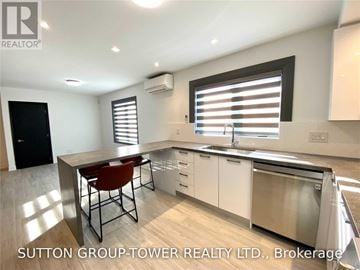 Toronto (Weston-Pellam Park) fourplex for rent - A modern kitchen with a dining table and chairs.