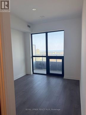 Mississauga (City Centre) condo for rent - A room with a large window and sliding glass doors.
