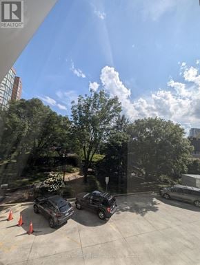 Toronto (Niagara) condo for rent - A parking lot with cars and orange cones.