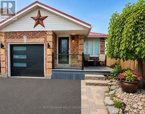 Barrie (Sunnidale) apartment for rent - A house with a red star on the roof and a number 62 on the brick wall.