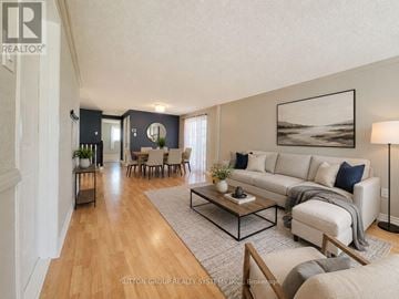 Barrie (Sunnidale) apartment for rent - A living room with a white couch and a coffee table.