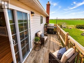 Barrie (Sunnidale) apartment for rent - A sunny day on a wooden deck with a chair and a table.