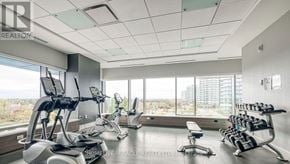 Mississauga (Central Erin Mills) condo for rent - A well-equipped gym with treadmills, stationary bikes, and dumbbells.