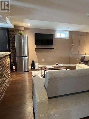 Oshawa (Taunton) apartment for rent - A living room with a grey couch and a television on the wall.